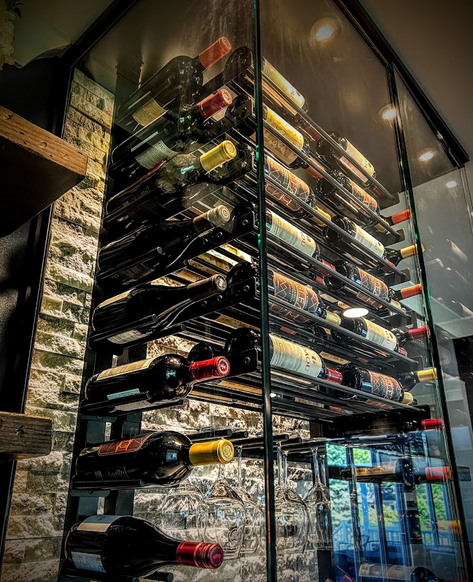 A custom wine cellar with glass enclosures.