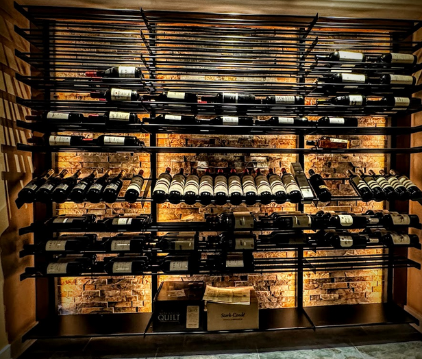 Metal wine racking displaying a wide collection of wine.