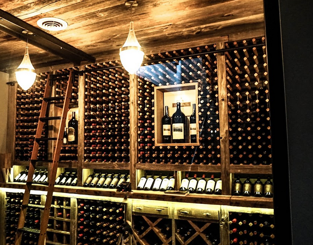 A wine tasting room featuring pendant and accent lights.