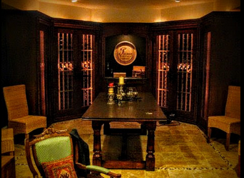A wine-tasting room featuring warm lighting and a metal racking system.