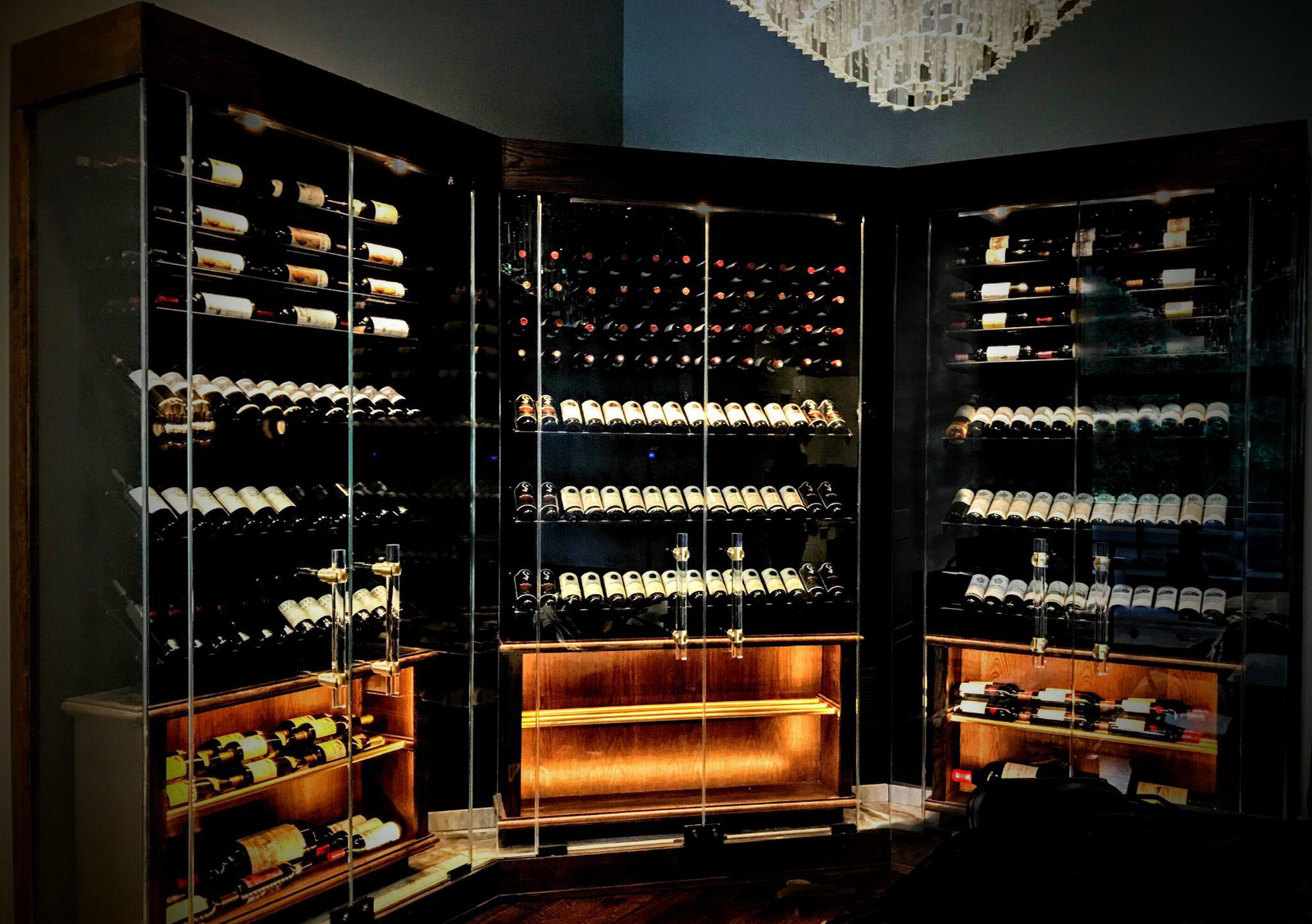 A wine cellar with metal racks and glass doors