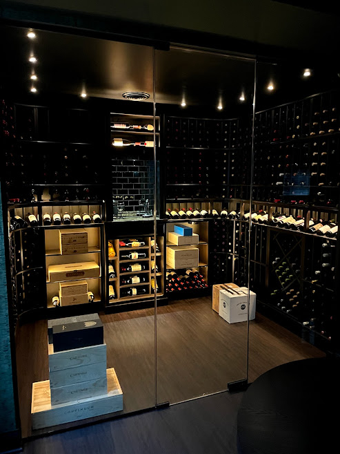 A technician installing a residential wine cellar with temperature control systems.