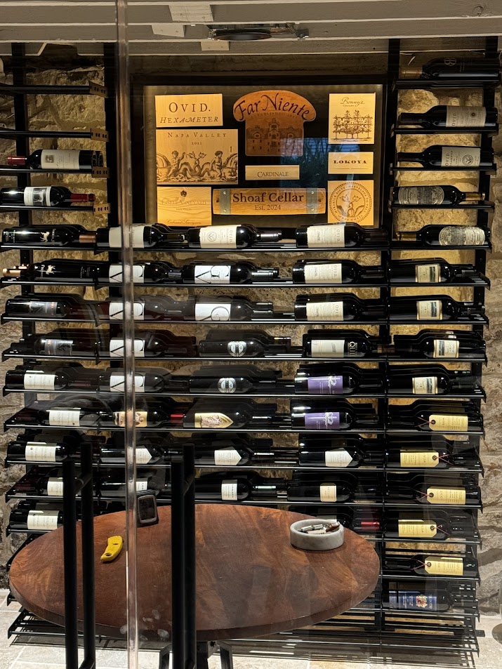 Baroque Design wine cellar featuring neatly arranged wine bottles behind a glass enclosure