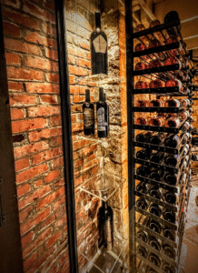 Modern custom wine cellar by Baroque Design featuring glass enclosure