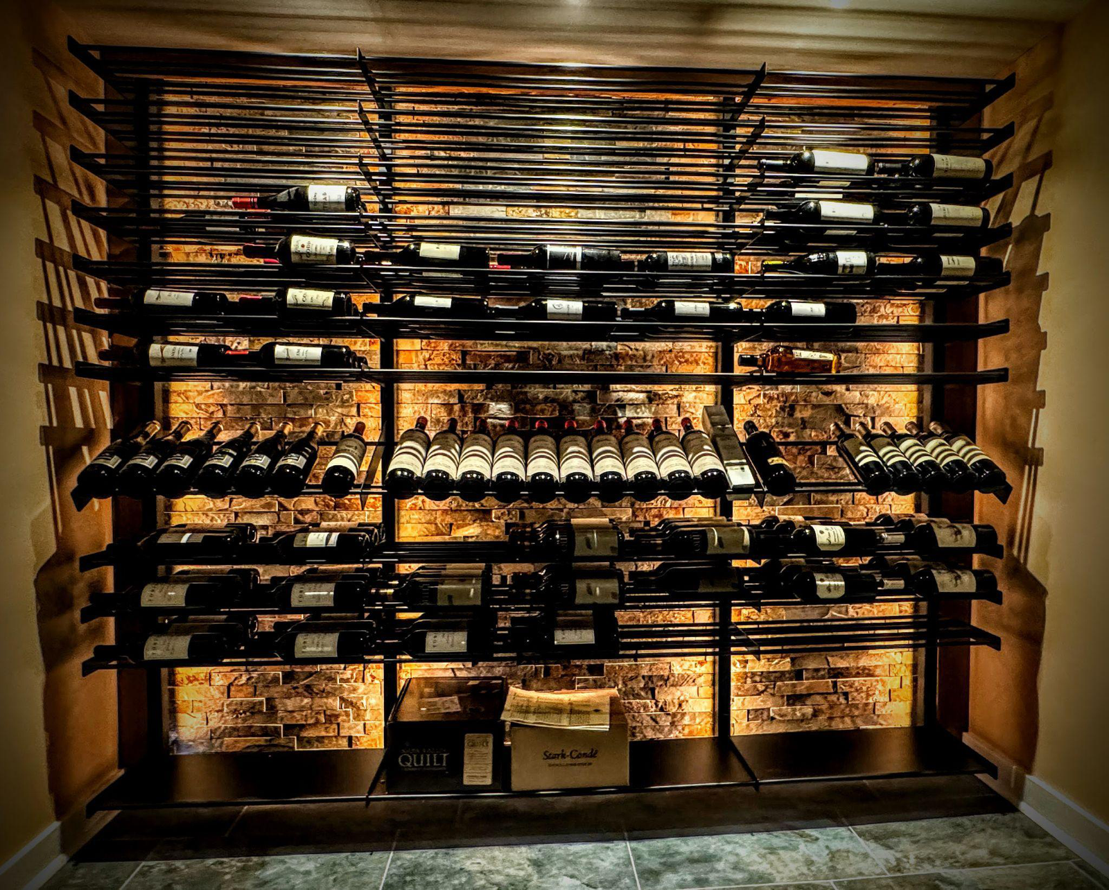 a shelf full of wine in a wine cellar
