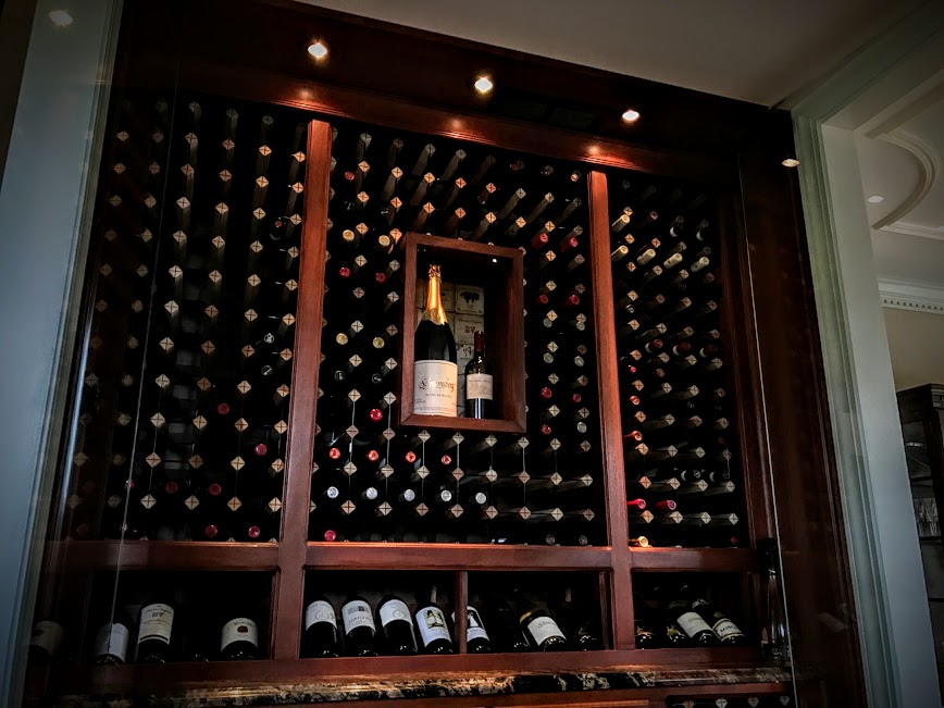 a shelf full of wine bottles in a wine cellar