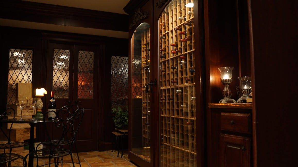a wine cellar with a shelf full of wine bottles and wooden architecture