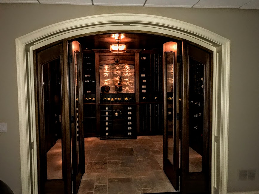 a wooden door opening to a wine cellar