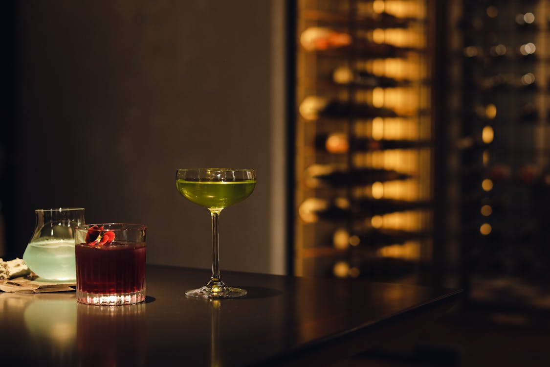 A large wine glass filled with wine on a wooden table