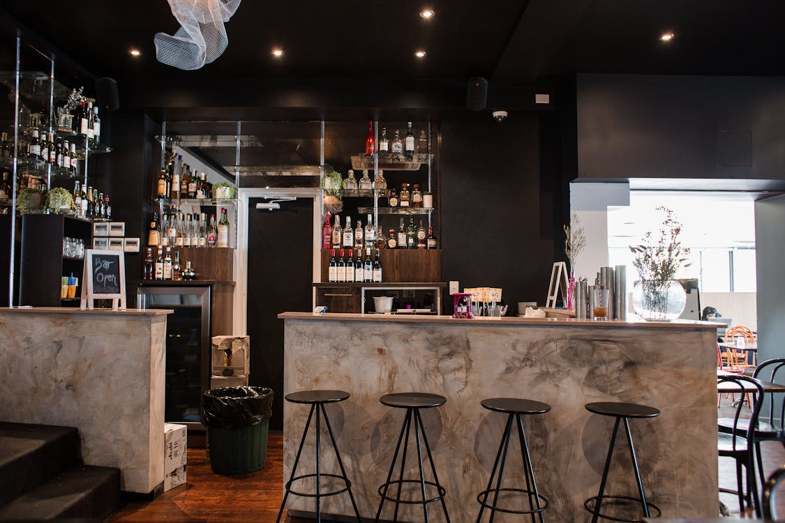 A modern aesthetic bar area with a unique wine cellar